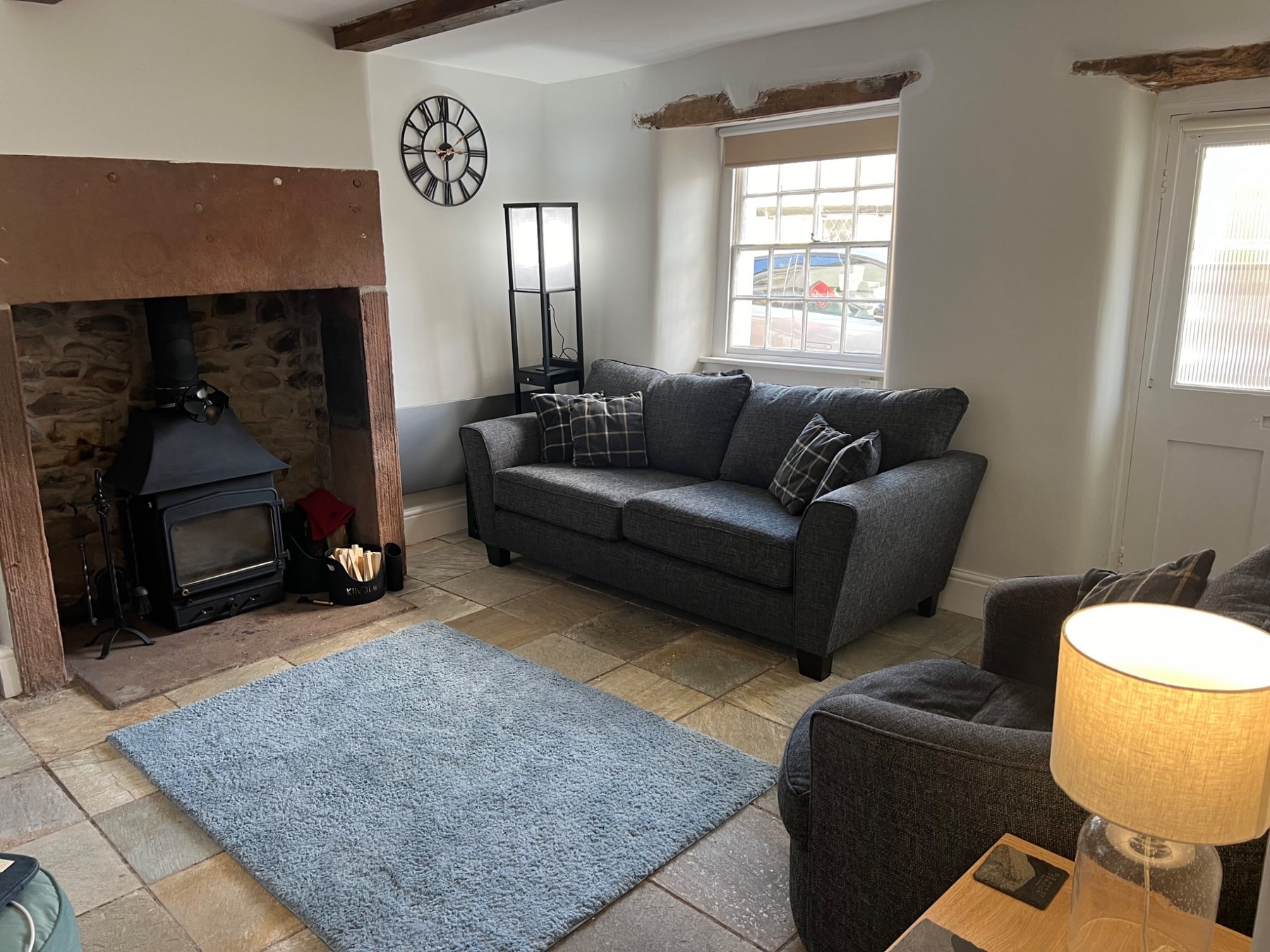 Cosy living room with exposed beams and wood-burning stove